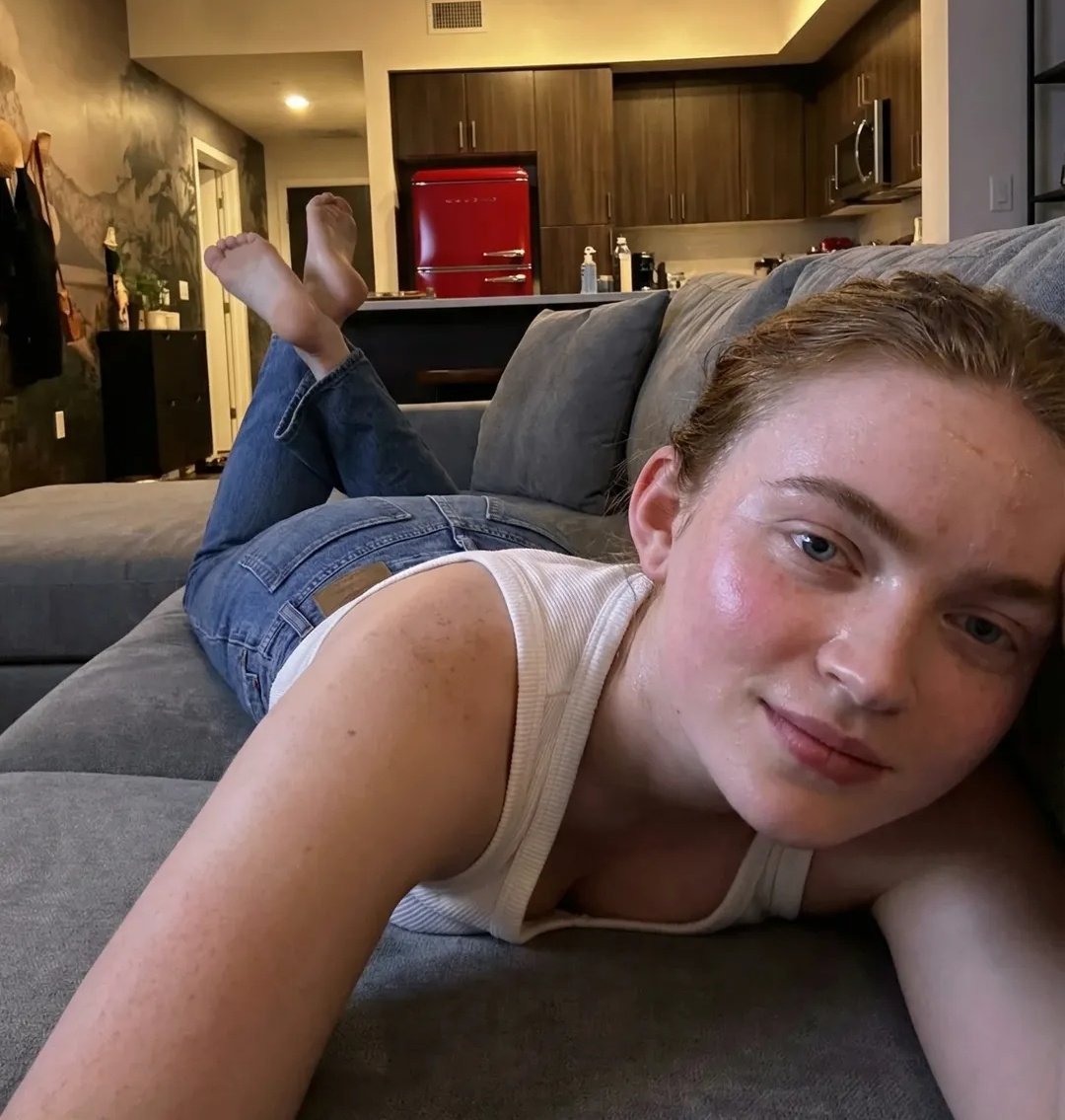 Woman Lounging on Sofa in Modern Apartment (#nb_828)